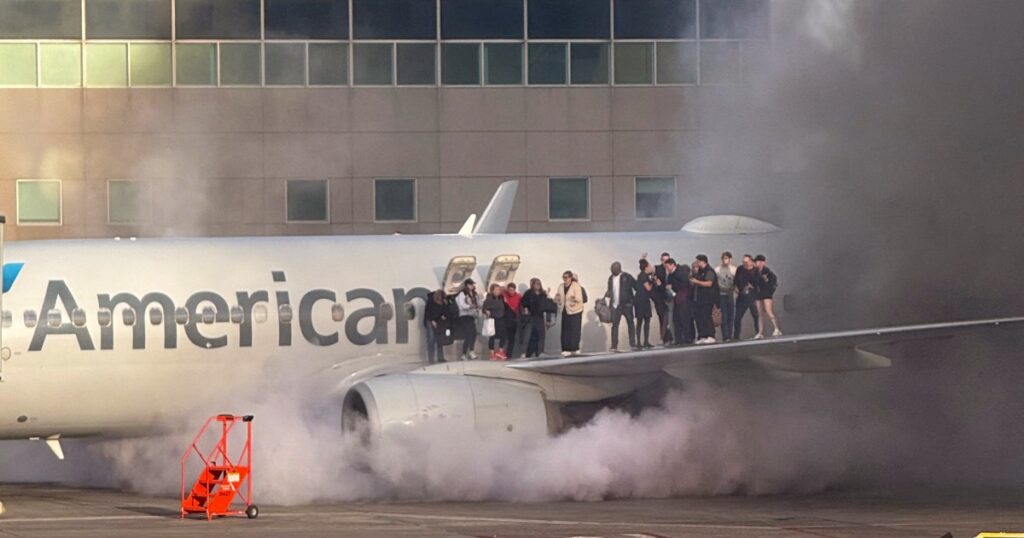 Passengers evacuate after American Airlines plane catches fire in Denver